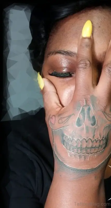 Skull hand tattoo