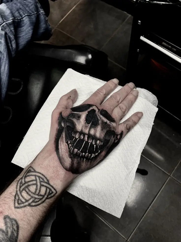 Skull hand tattoo