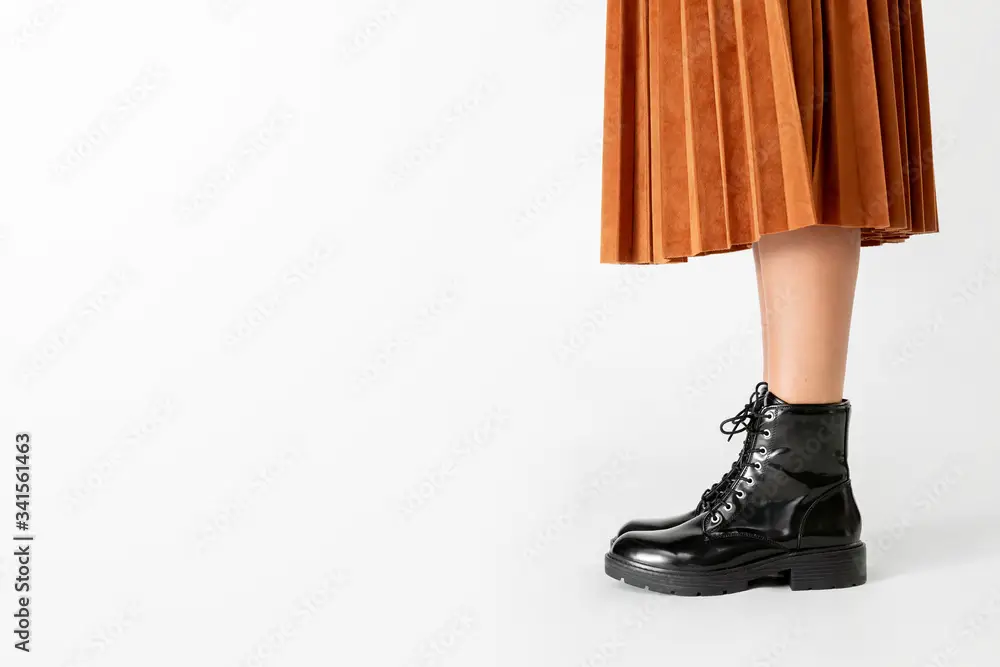 Woman in a skirt wearing combat boots
